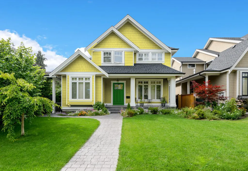 forest green front door with yellow house