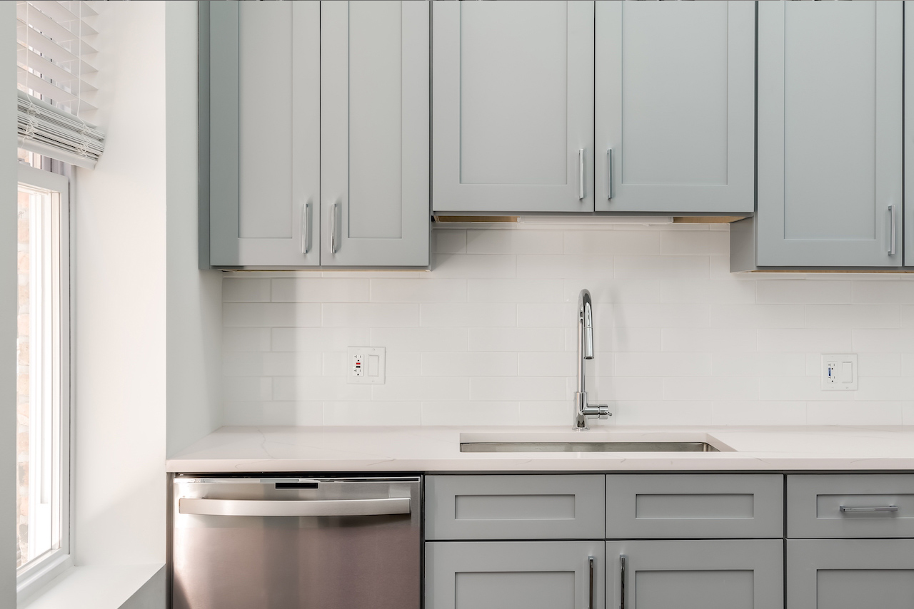 snow white marble countertops with gray kitchen cabinets