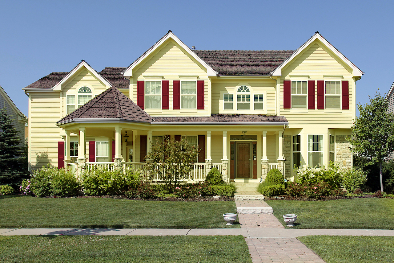 regal red shutters and yellow house