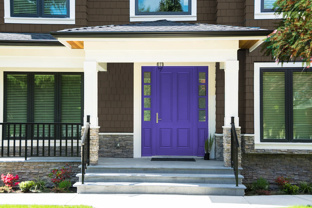 slate blue front door and dark brown house