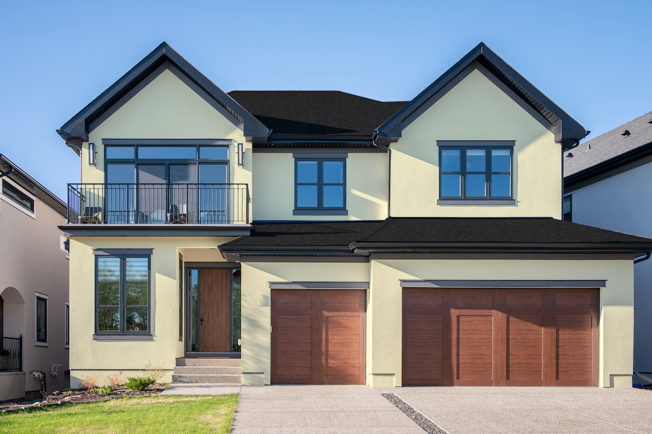 creamy vanilla house with black roof